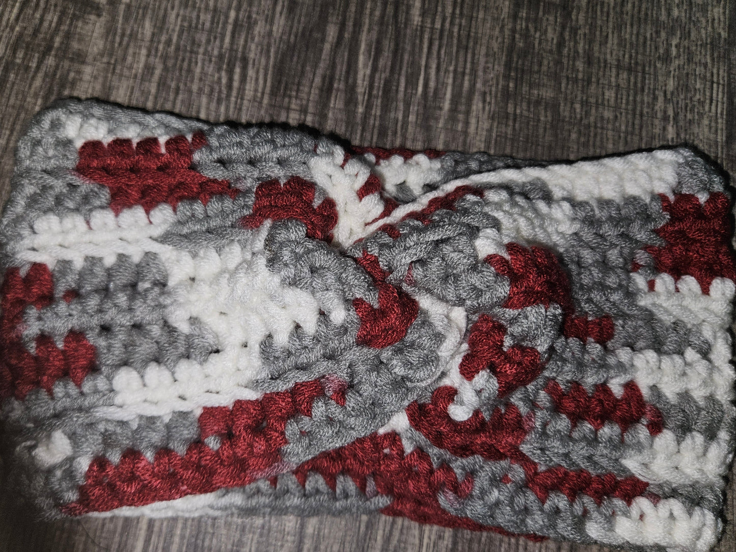 Gray and red patterned fabric on a wooden surface