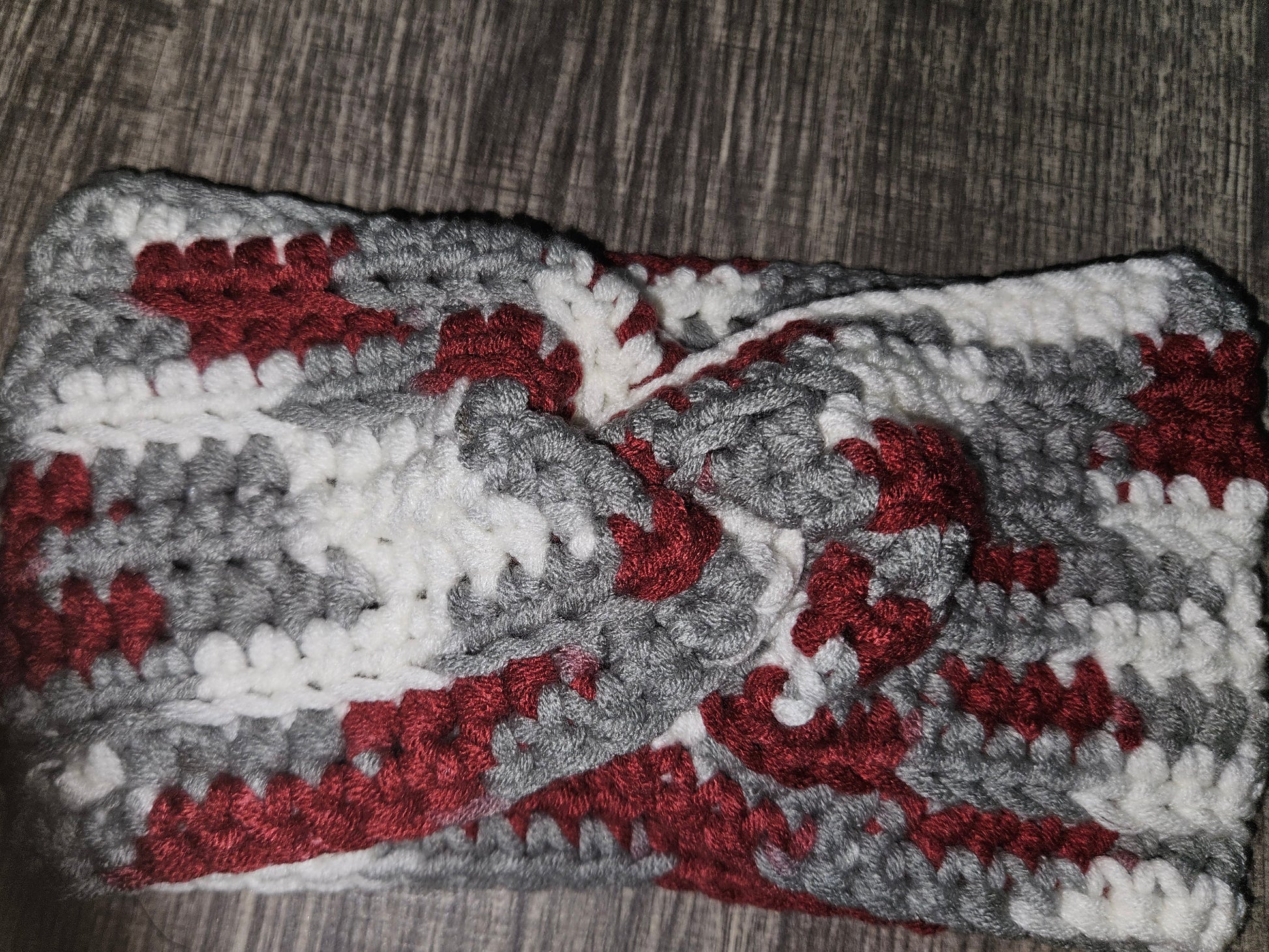 Gray and red patterned fabric on a wooden surface